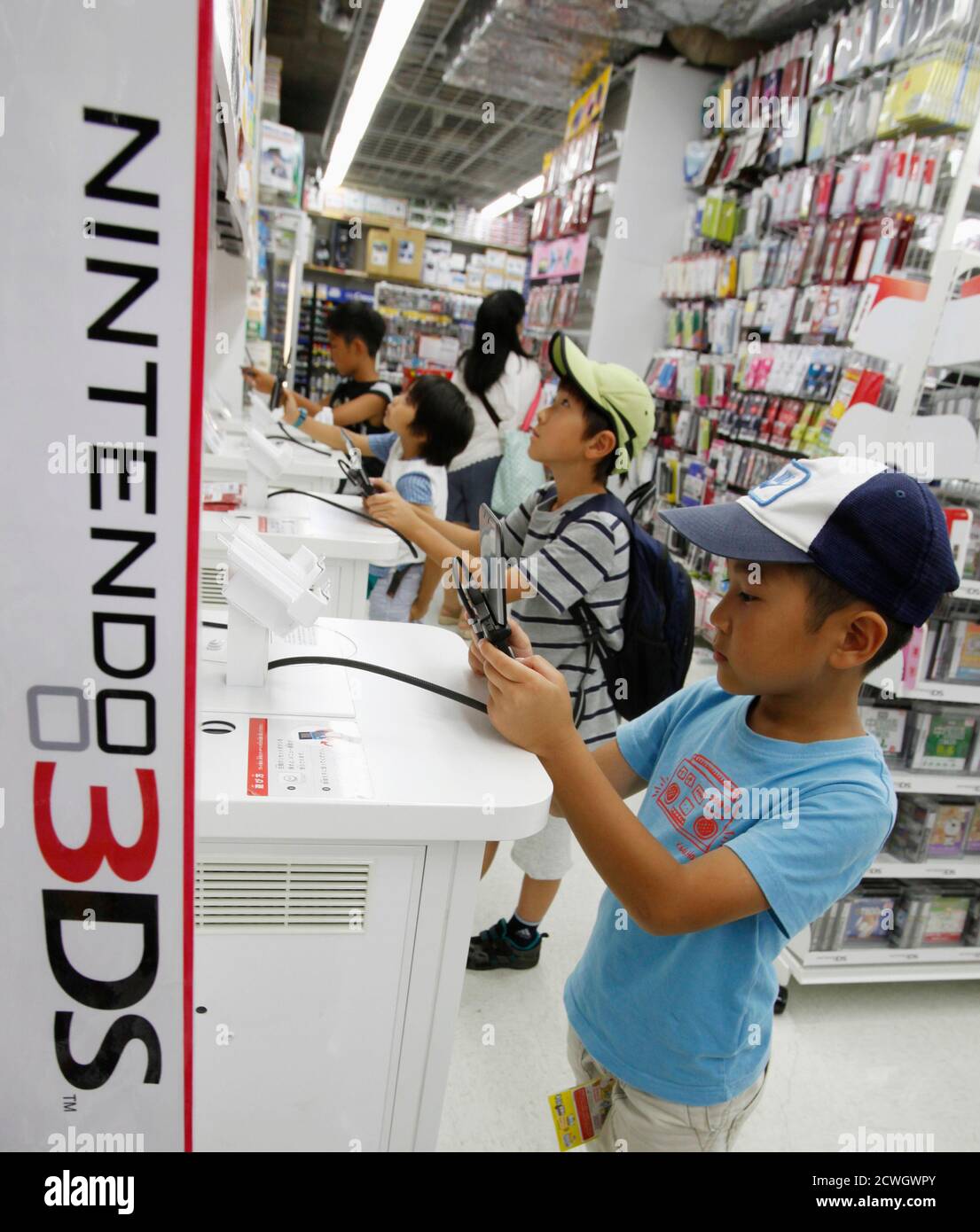 Boys try out Nintendo's 3DS game software at an electronic store in Tokyo  July 25, 2012. Nintendo Co said on Wednesday sales of its Wii game machines  totalled 710,000 in the April-June