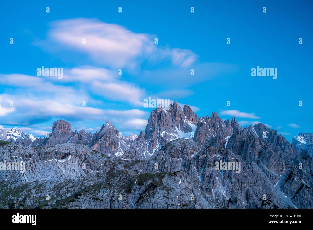 Dusk lights over the rocky peaks of Cadini di Misurina mountain group, Dolomites, Belluno province, Veneto, Italy Stock Photo