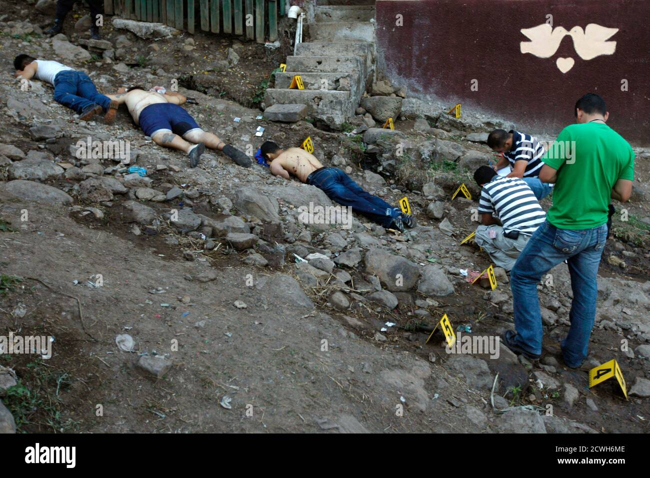 ATTENTION EDITORS - VISUAL COVERAGE SCENES OF INJURY OR DEATH Three unidentified slain men lay dead at Nueva Danli neighborhood in Tegucigalpa, November 28, 2010. According to Ramon Custodio, National Commissioner of Human Rights, the rate of homicides in 2010 in Honduras was of 72.8 homicides per 100,000 inhabitants, the highest in the world. REUTERS/Edgard Garrido (HONDURAS - Tags: OBITUARY CIVIL UNREST IMAGES OF THE DAY) Stock Photo