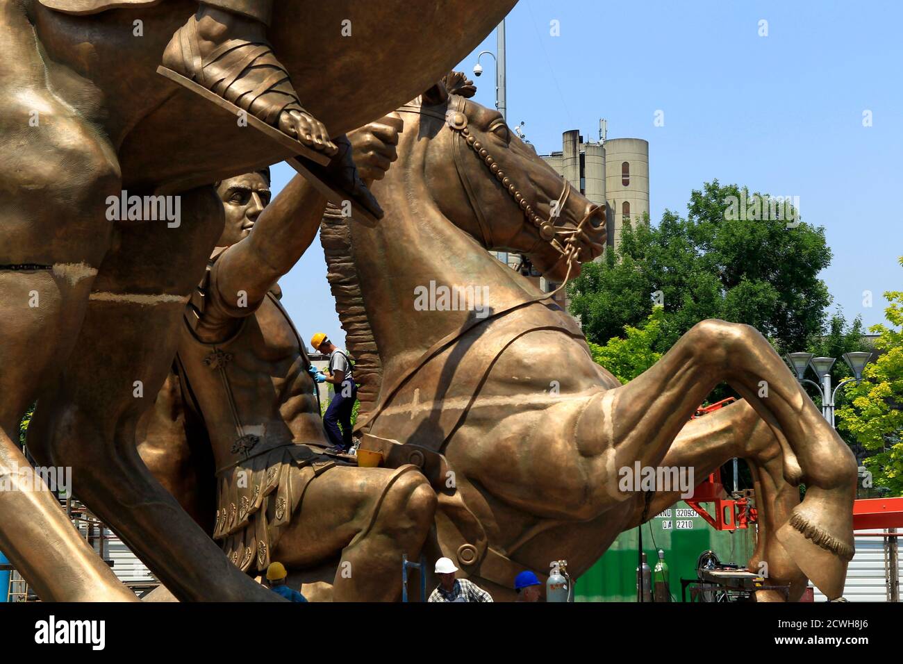 A worker stands on a monument of Alexander the Great on his horse  Bucephalus in Skopje's central city square June 18, 2011.The bronze  installation of 12.5 meters (41 feet) high, standing on