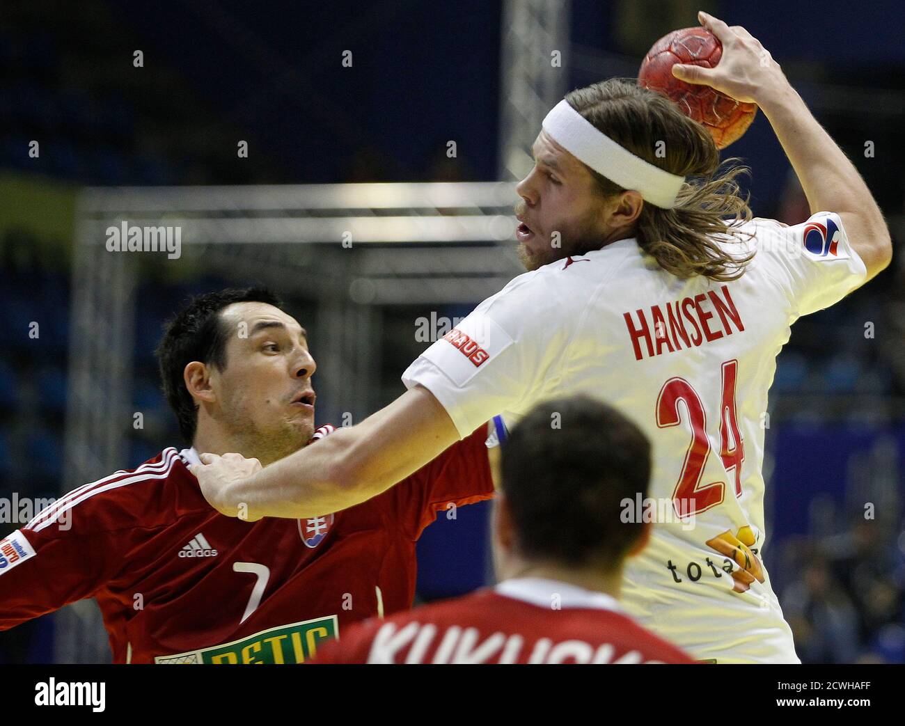 Denmark's Mikkel Hansen (R) tries to score against Slovakia's Peter Dudas  (C) and Peter Kukucka during their Men's European Handball Championship  Group A match in Belgrade January 15, 2012. REUTERS/Marko Djurica (SERBIA -