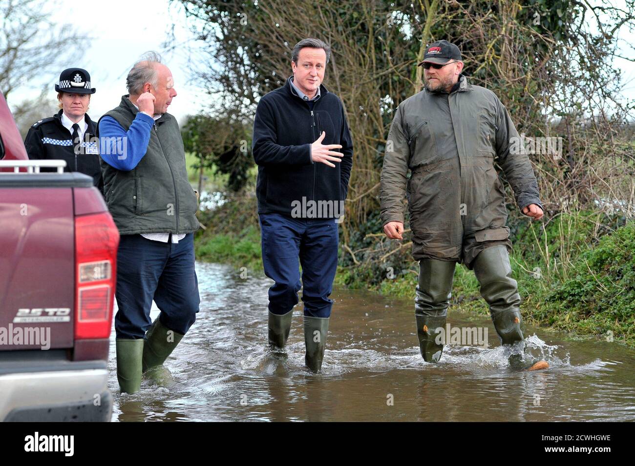 Britain's Prime Minister David Cameron (2nd R) with Bridgwater and West Somerset MP Ian Liddell-Grainger (2nd L), chat with farmer Tony Davy (R) during a visit flood affected areas at Goodings Farm in Fordgate, Somerset February 7, 2014. REUTERS/Tim Ireland/Pool (BRITAIN - Tags: ENVIRONMENT DISASTER POLITICS) Stock Photo