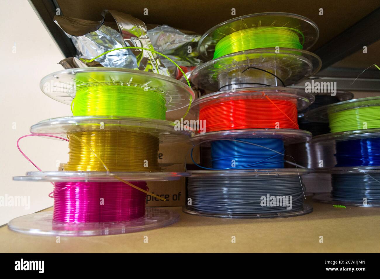 3d Printed Color Stack Stacks of 3d printing filament in different colors lying on metal shelf ...