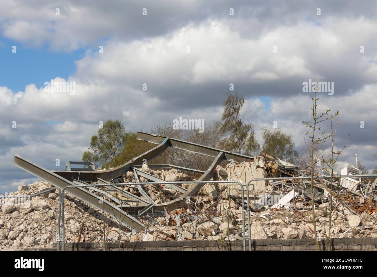 Pile of concrete rubble and twisted metal girders at demolition in progress of the former Bury police headquarters building on  Irwell Street, Bury. Stock Photo