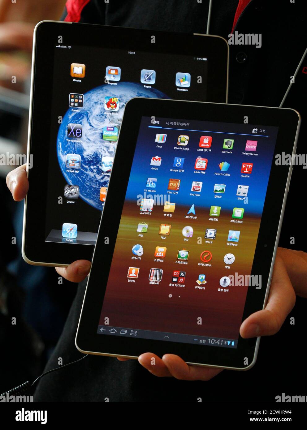 https www alamy com an employee of south korean mobile carrier kt holds a samsung electronics galaxy tab 101 tablet front and apple incs ipad tablet as he poses for photos at a registration desk at kts headquarters in seoul august 10 2011 apple inc scored a big victory in its patent infringement battle against samsung electronics after a german court barred the korean firm from temporarily selling its flagship galaxy tablet in the european union except the netherlands reutersjo yong hak south korea tags crime law business sci tech image377176048 html