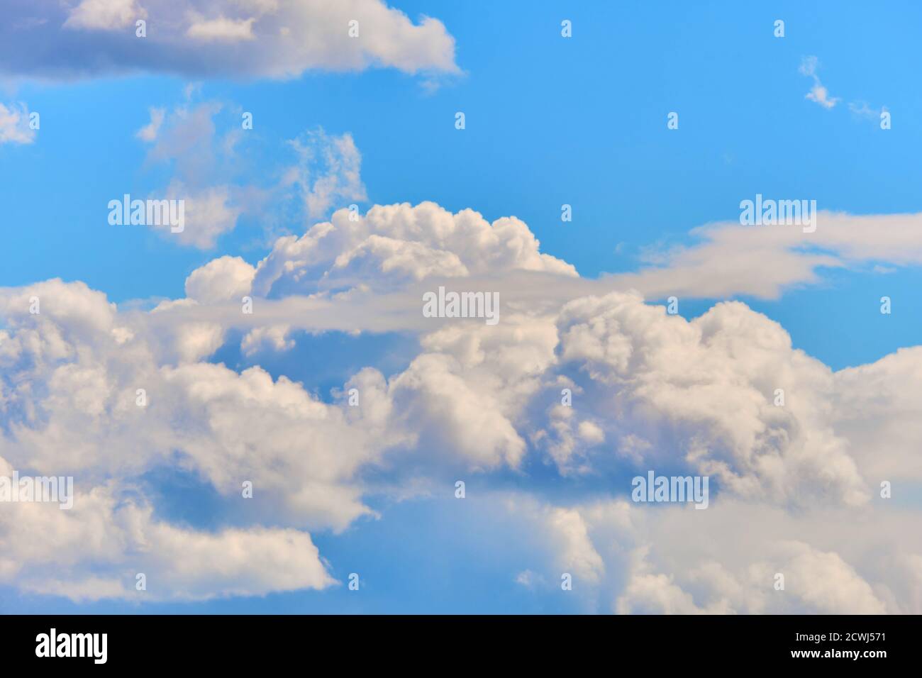 There are many thick white clouds in the sky. Heavy cloudiness Stock