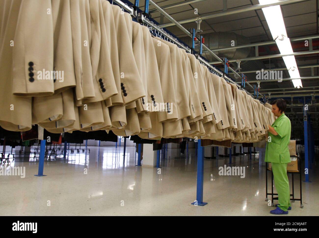 A woman works at the Zara factory at the headquarters of Inditex group in  Arteixo, northern Spain, July 15, 2011. Amancio Ortego, Spain's richest man  and founder of clothing label Zara, stepped