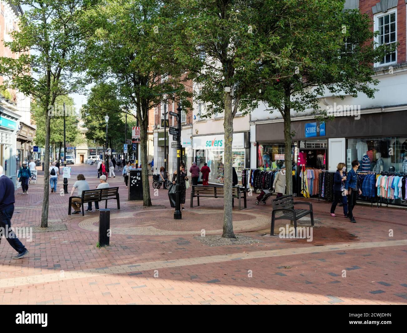 Pedestrianised streets in the centre of Rugby town with people shopping in covid times Stock Photo