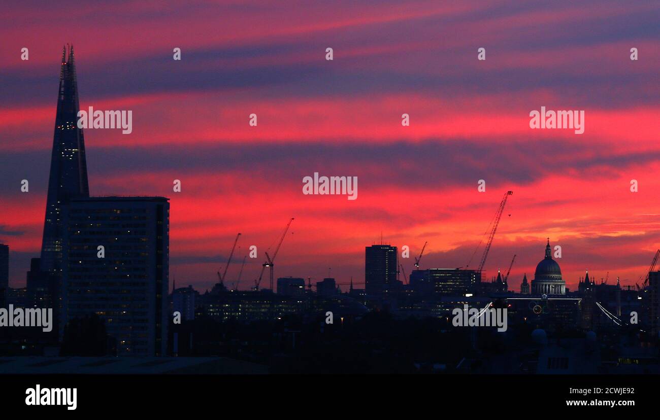 A sunset is seen behind The Shard (L) and St Pauls Cathedral (R) in London July 30, 2012.     REUTERS/Eddie Keogh (BRITAIN - Tags: SPORT OLYMPICS CITYSPACE) Stock Photo