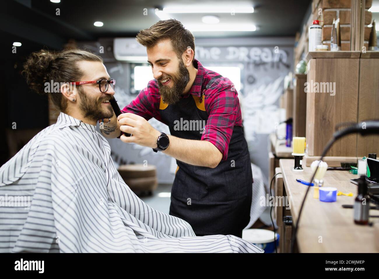 Client during beard shaving in barber shop Stock Photo - Alamy