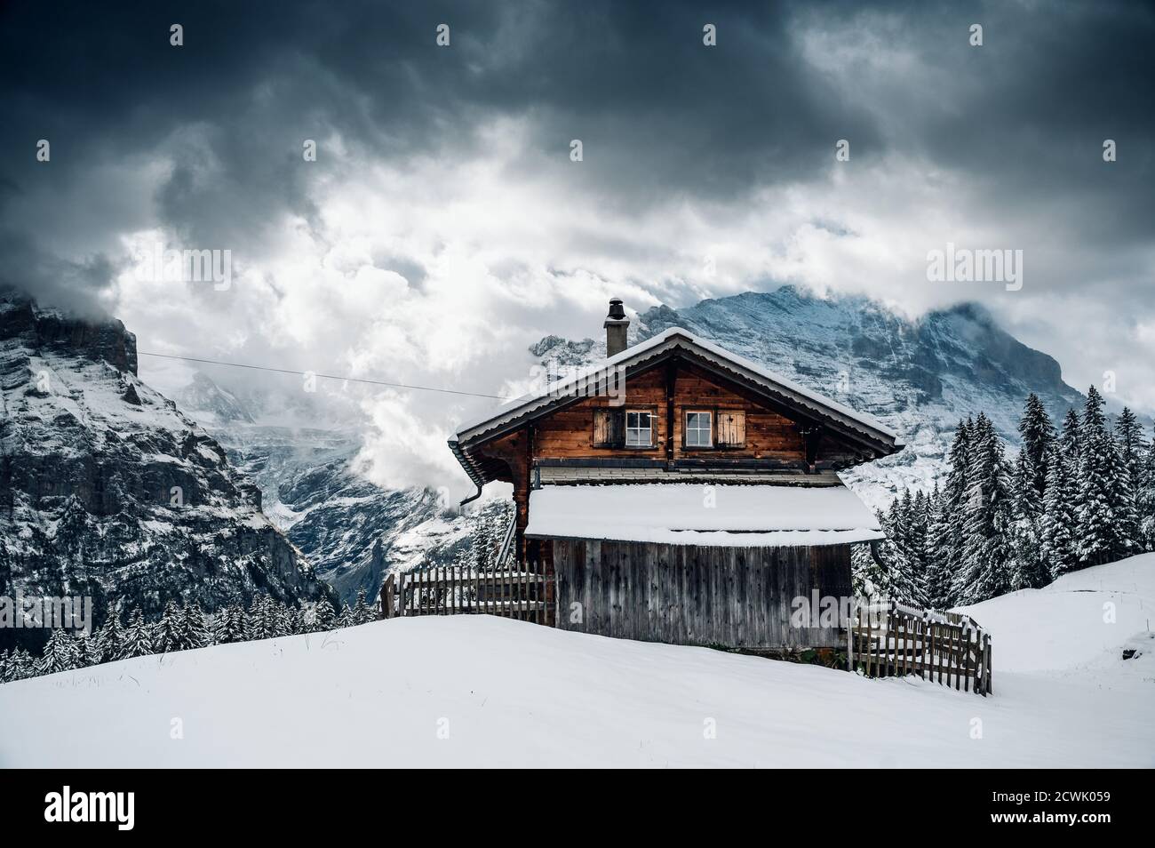 wooden cottage in a winter fairytale landscape above Grindelwald Stock