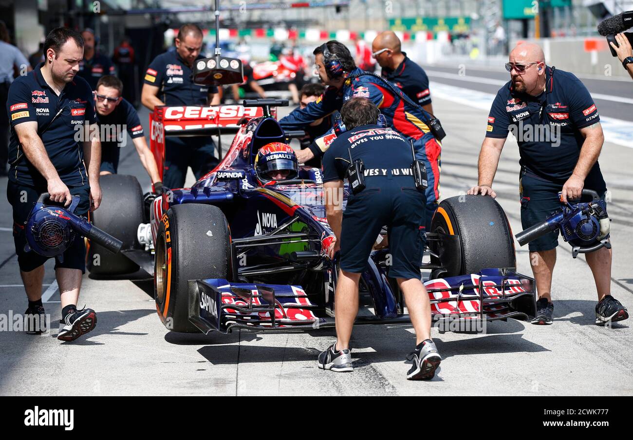 Crew Members Push Toro Rosso Formula One Driver Max Verstappen Of The Netherlands Back Into The Garage During The First Practice Session Of The Japanese F1 Grand Prix At The Suzuka Circuit