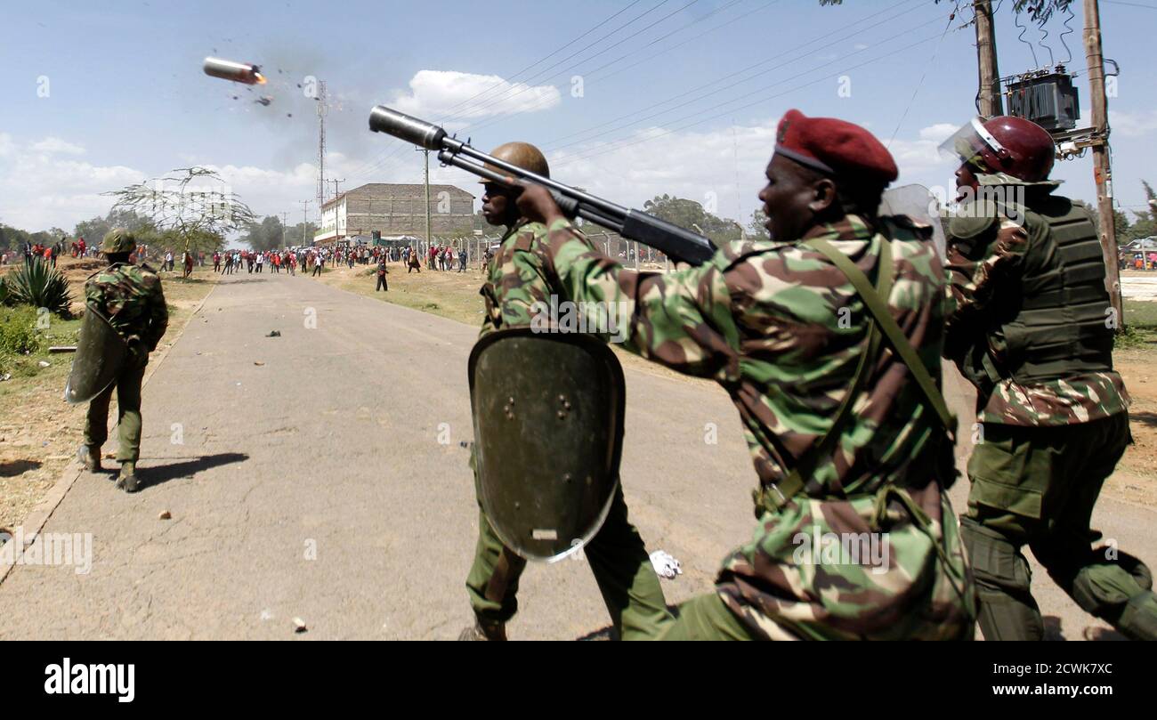 A riot policeman fires a teargas canister to disperse demonstrators during protests to oust Narok county Governor Samuel Tunai in Narok, Kenya, January 26, 2015. At least seven people were injured on Monday in clashes between Kenyan police and protesters from the Maasai ethnic group who accuse a local governor of corrupt handling of tourism funds from the Maasai Mara game reserve, the Kenya Red Cross said. REUTERS/Thomas Mukoya (KENYA - Tags: CIVIL UNREST POLITICS CRIME LAW TRAVEL) Stock Photo