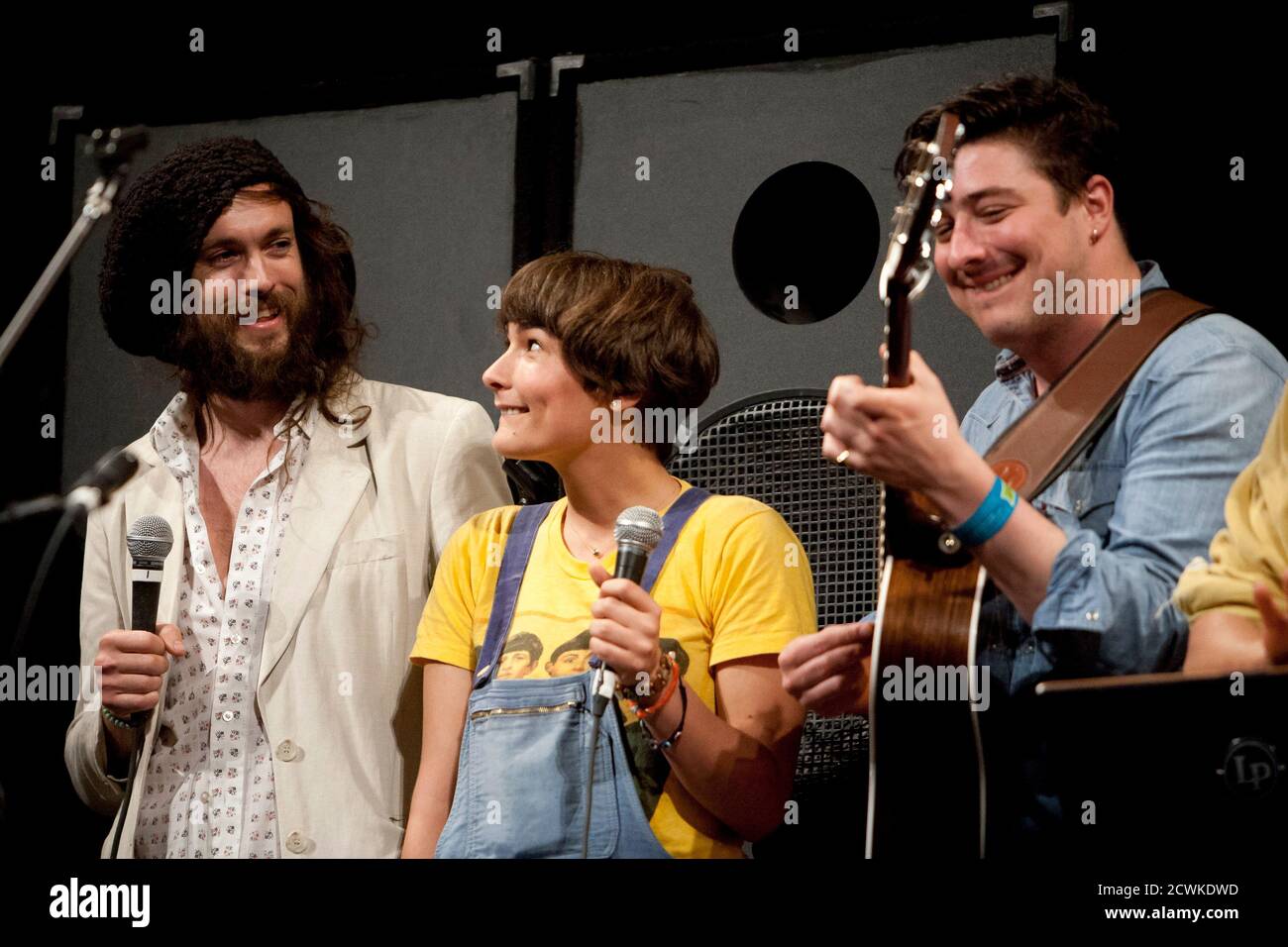 Alex Ebert and Jade Castrinos, of Edward Sharpe and the Magnetic Zeros, and  Marcus Mumford of Mumford & Sons, (L-R) share the stage during a  performance at the Paramount Theater during the