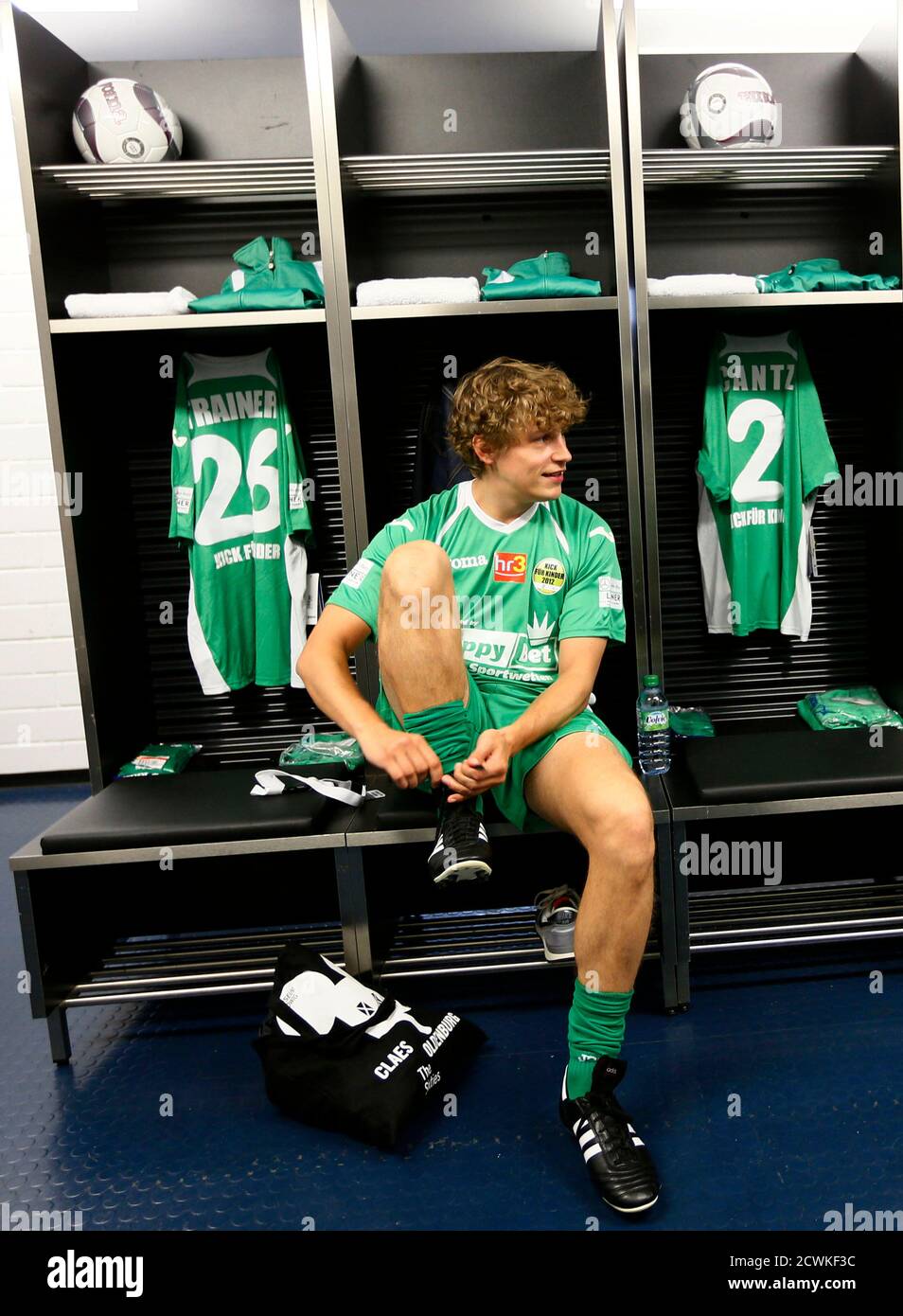 German singer Tim Bendzko gets ready in the dressing room prior to the  charity soccer match "Kick for Kids", with Germany's Red Bull Formula One  World Champion Sebastian Vettel and his compatriot