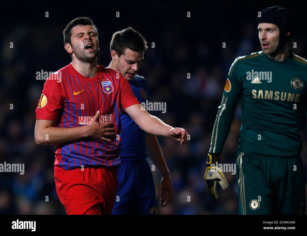 Steaua Bucharest's Raul Rusescu reacts as Chelsea's Cesar Azpilicueta and  goalkeeper Petr Cech look on during their Europa League soccer match at  Stamford Bridge in London March 14, 2013. REUTERS/Suzanne Plunkett (BRITAIN  -