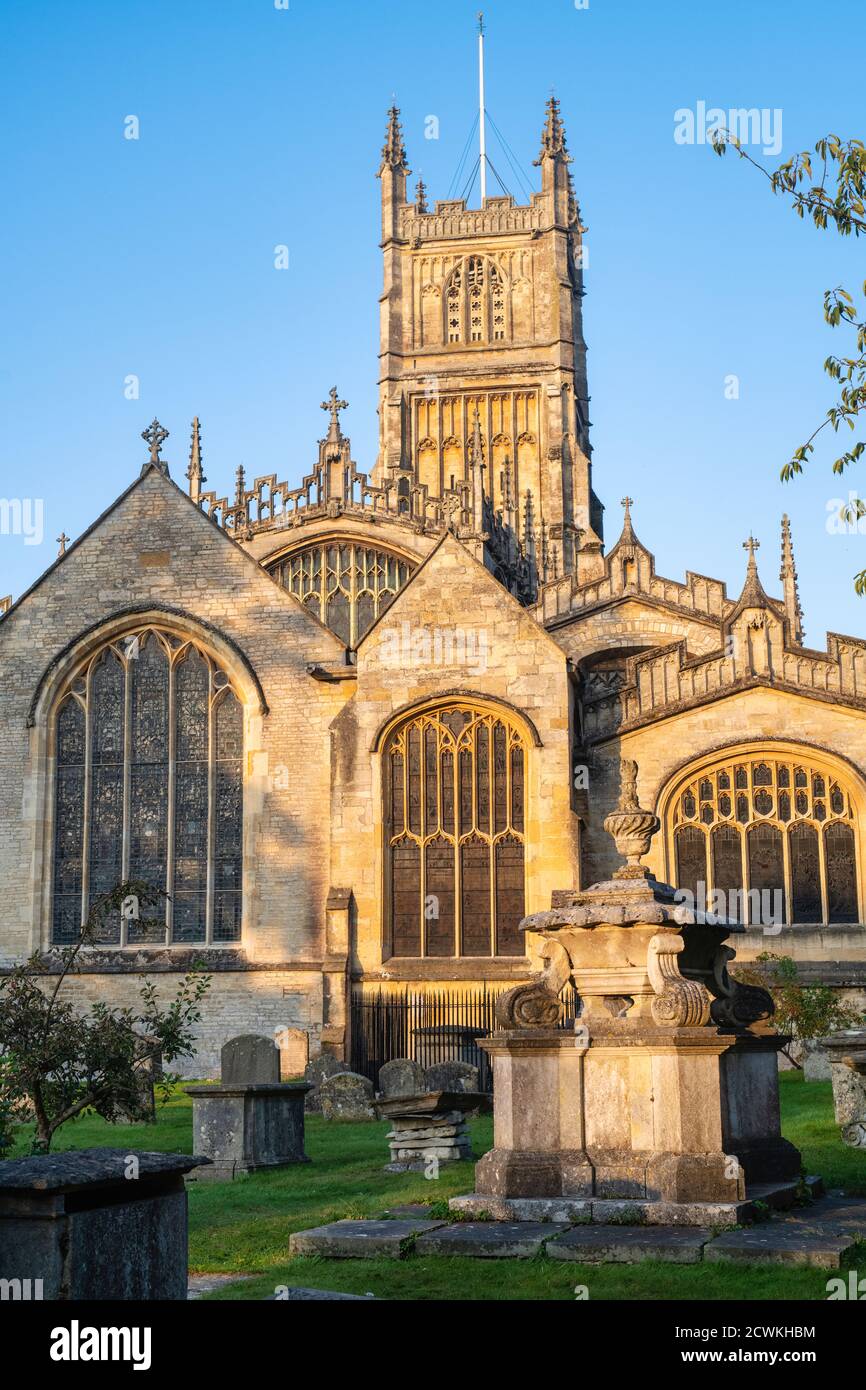 The Church of St. John the Baptist from the garden of rememberance at sunrise in autumn. Cirencester, Cotswolds, Gloucestershire, England Stock Photo