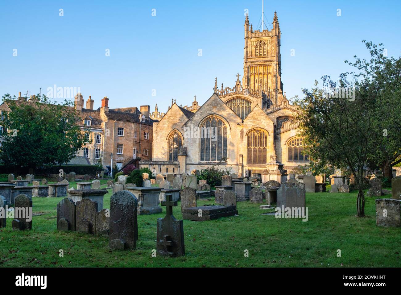 The Church of St. John the Baptist from the garden of rememberance at sunrise in autumn. Cirencester, Cotswolds, Gloucestershire, England Stock Photo