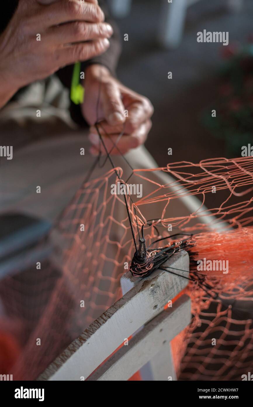 A Fisherman Mending his Fishing Net Stock Photo Alamy