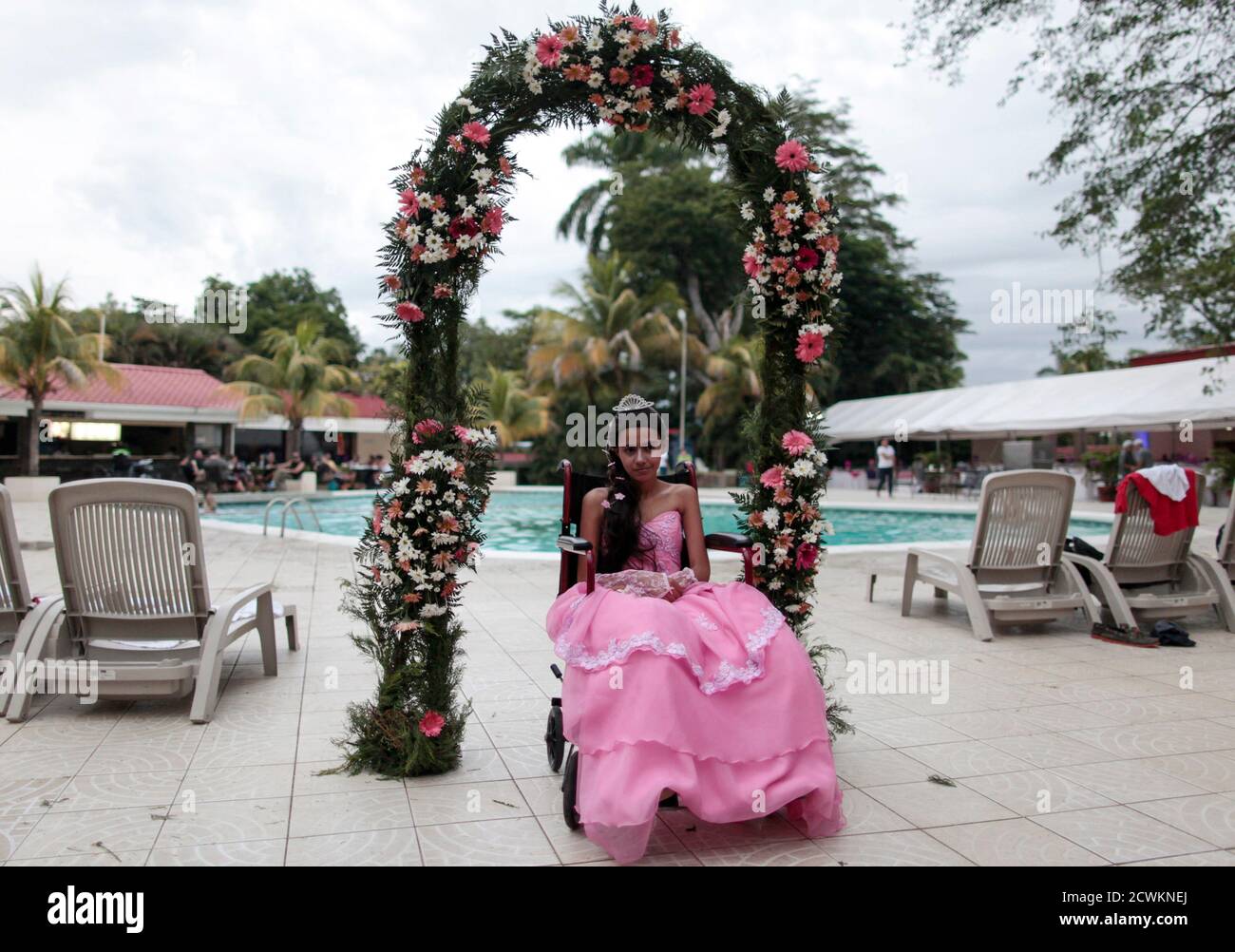 A cancer patient poses for a photo during her "Quinceanera" (15th birthday) party at a hotel in Managua September 20, 2014. Quinceaneras are a traditional celebration for girls turning 15. The Nicaragua's Association of Mother and Father of Children with Leukemia and Cancer (MAPANICA) organizes quinceaneras for cancer patients annually, and there were 44 celebrants in 2014. Picture taken September 20, 2014. REUTERS/Oswaldo Rivas (NICARAGUA - Tags: HEALTH SOCIETY TPX IMAGES OF THE DAY) Stock Photo