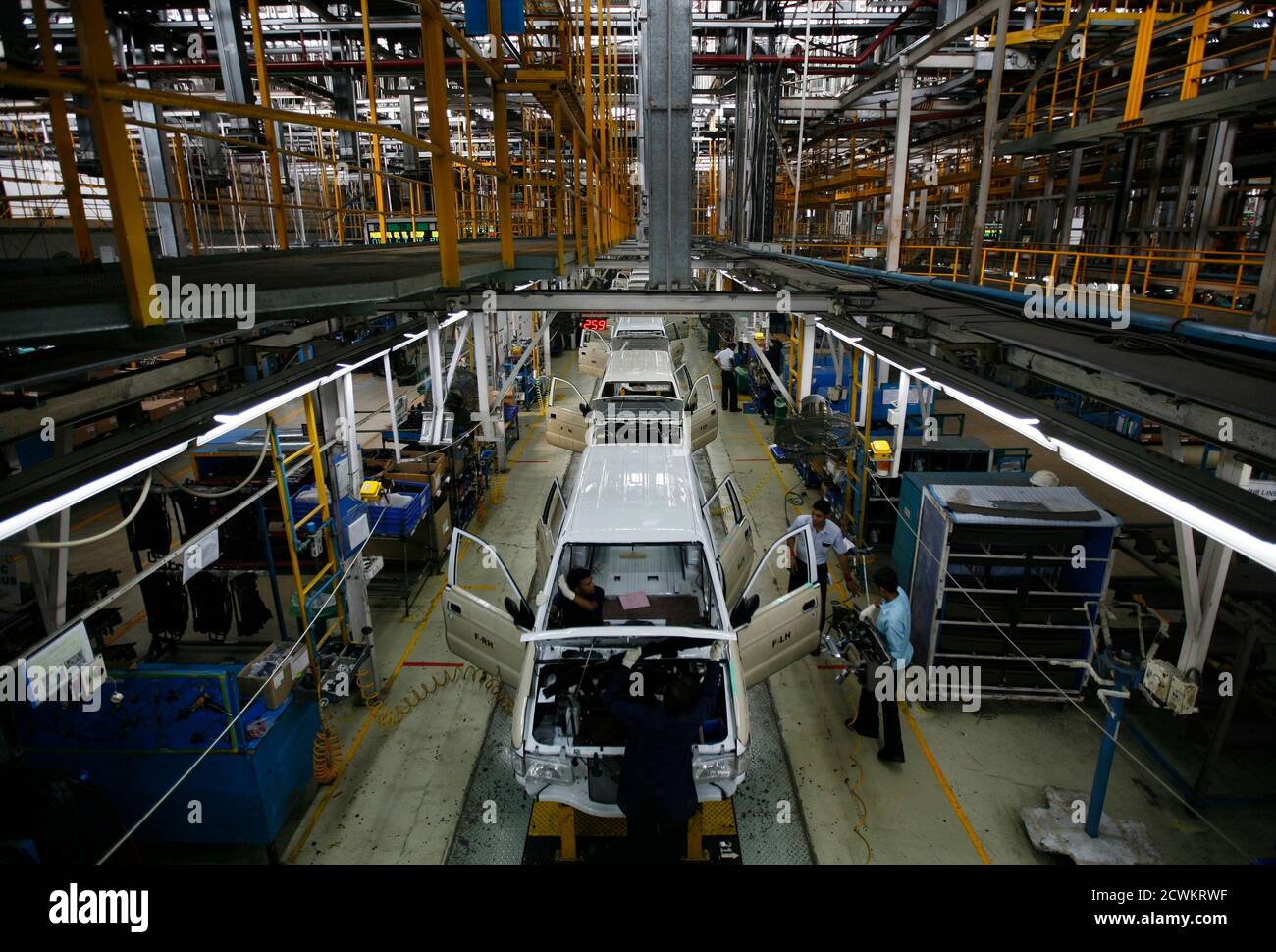 Employees work on the Chevrolet Tavera compact MPV assembly line inside a plant of General Motors India Ltd. at Halol, east of the western Indian city of Ahmedabad, September 22, 2010. REUTERS/Amit Dave (INDIA - Tags: TRANSPORT BUSINESS) Stock Photo