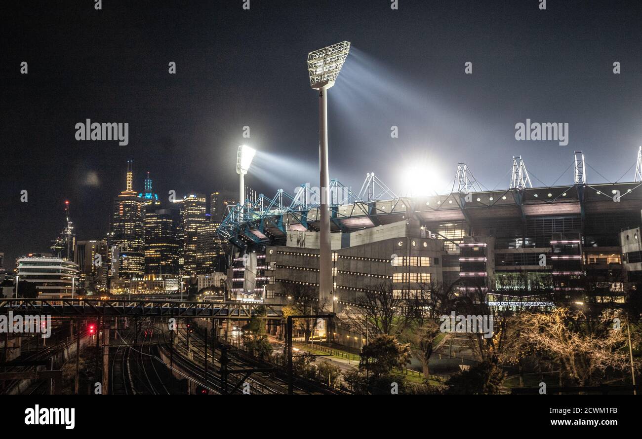 Melbourne Australia : The Melbourne Cricket Ground (MCG) flood lights and city skyline at night. Stock Photo