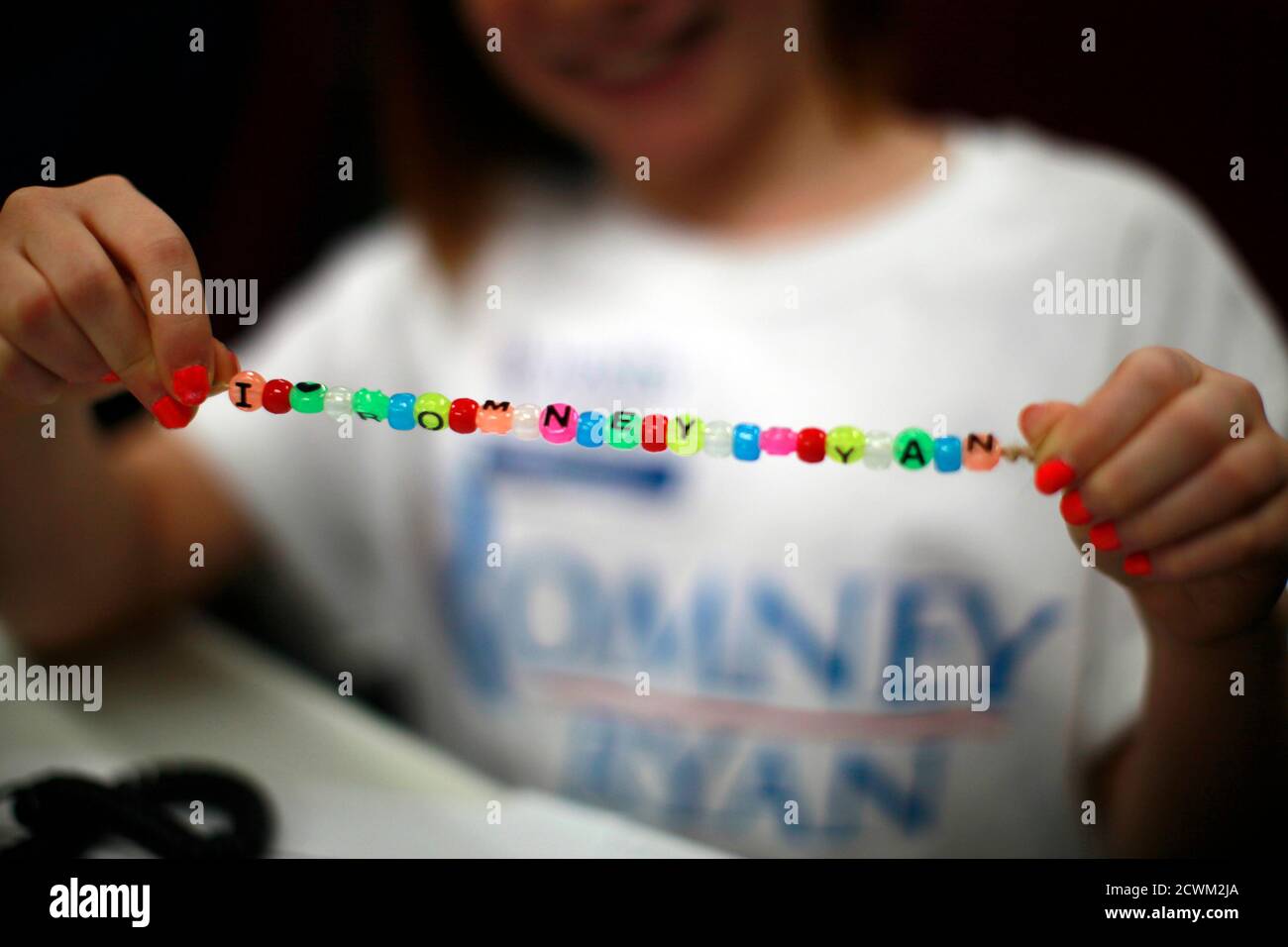 Claire Sorenson, 9, a volunteer making phone calls on behalf of U.S. Republican presidential candidate Mitt Romney, displays a bracelet she made at Romney's headquarters in Lakewood, Colorado October 30, 2012. The U.S. presidential election is exactly one week away. REUTERS/Rick Wilking (UNITED STATES - Tags: POLITICS ELECTIONS USA PRESIDENTIAL ELECTION) Stock Photo