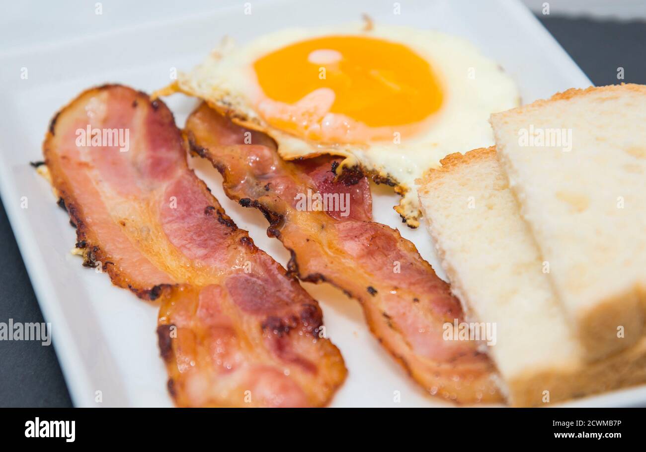 Fried egg and bacon plate Stock Photo - Alamy