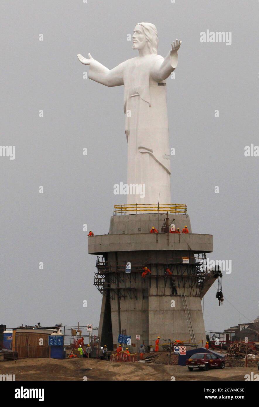 People work on the construction of a statue named "Christ of the Pacific"  which overlooks Lima from the top of Morro Solar hill in Lima's district of  Chorrillos June 16, 2011. The