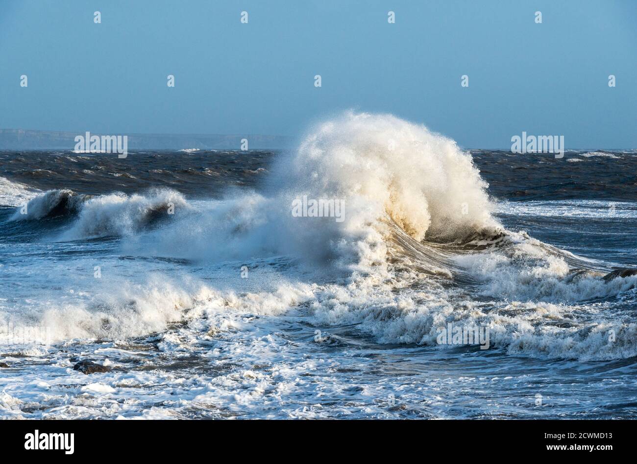 A breaking wave on a rough and stormy day, seen from the breakwater at Porthcawl, south Wales, UK Stock Photo