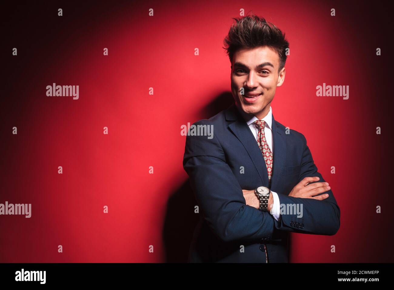portrait of confident young businessman in black suit with red tie ...