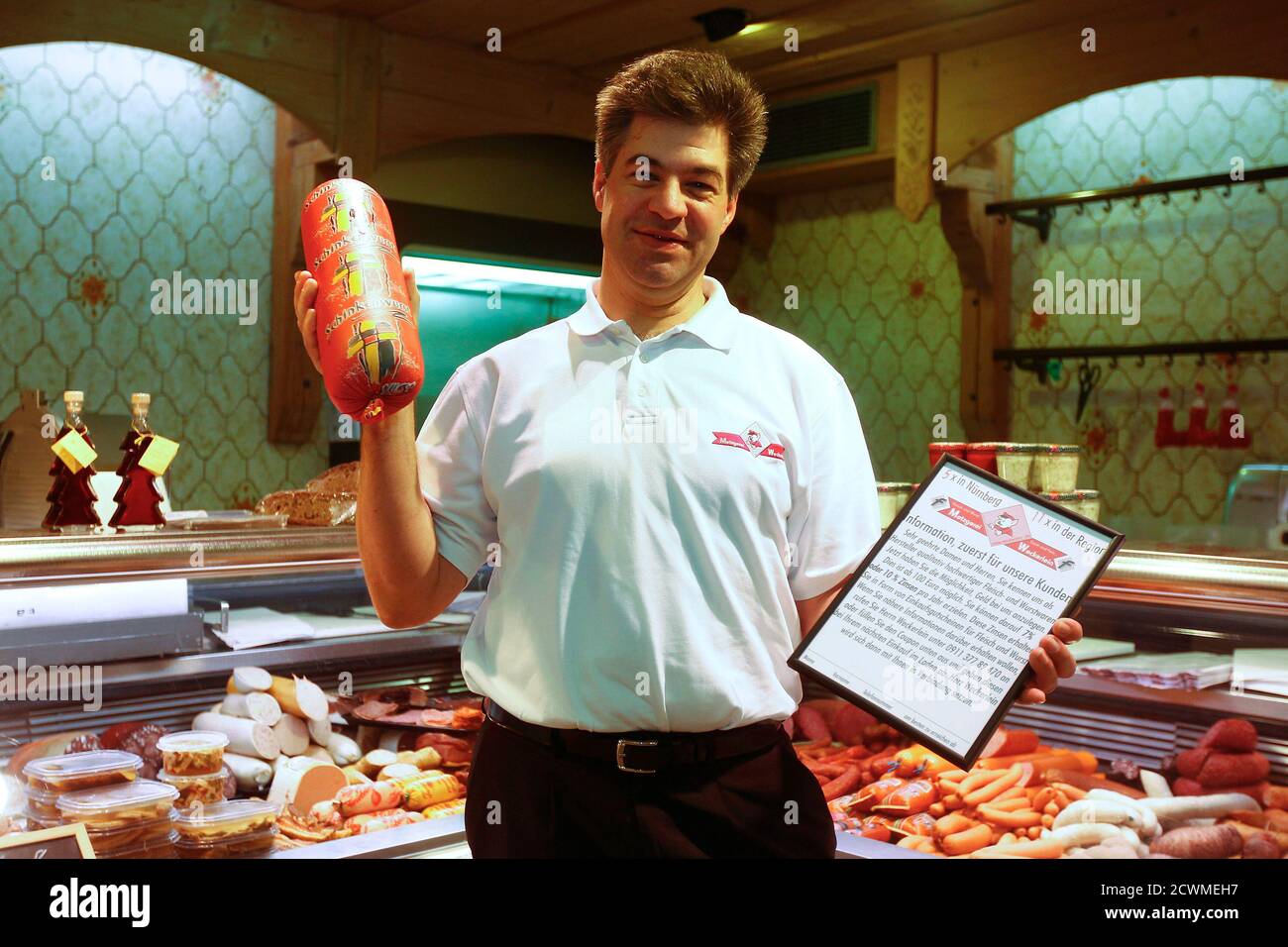 Butcher Joerg Weckerlein poses in his shop in Nuremberg to promote the  so-called "sausage share" (Wurstaktie), January 11, 2012. Customers can  subscribe for the share with an amount between 100 - 9000 ? (