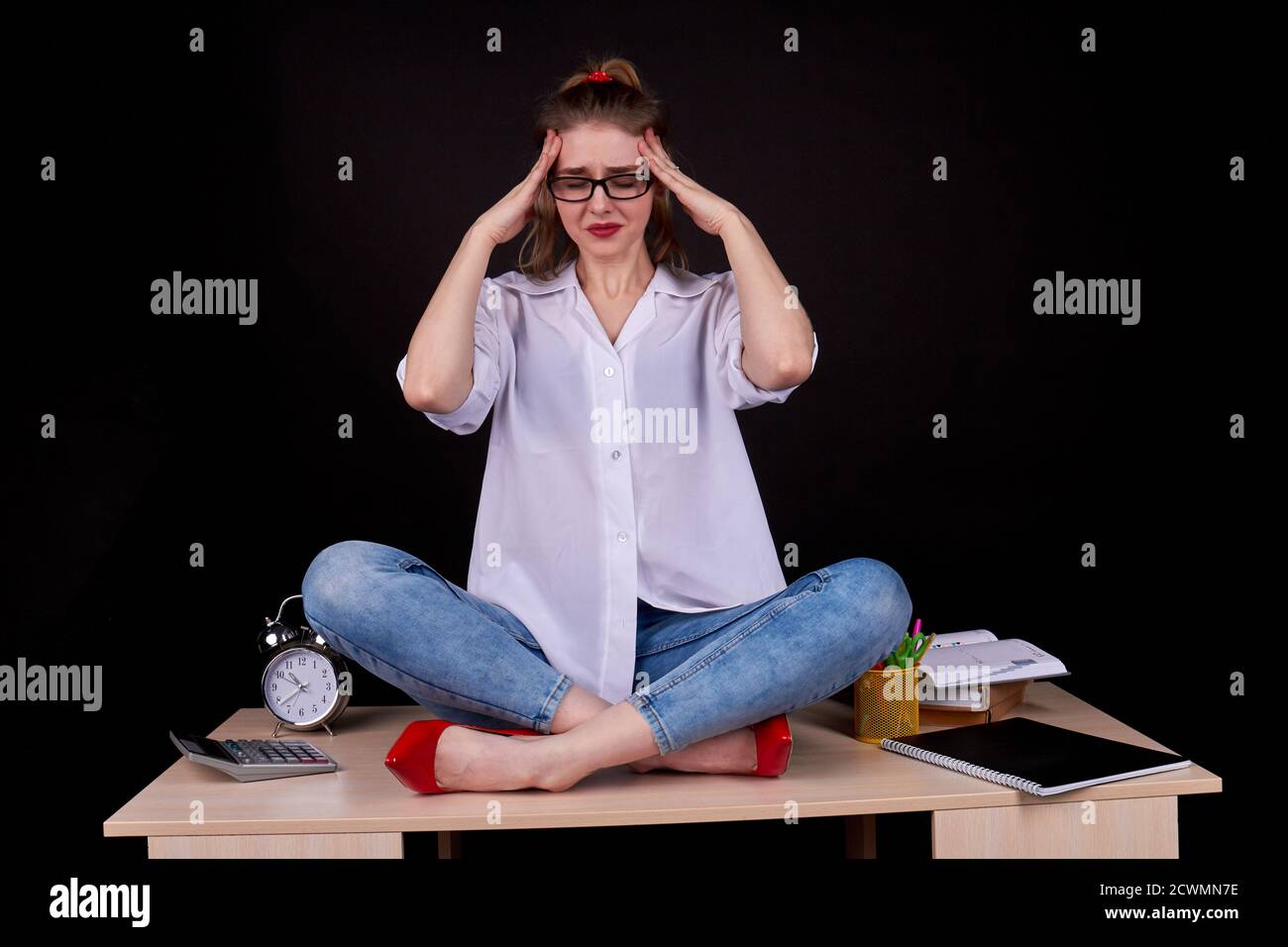 Sad student girl is touching her temples. Stock Photo