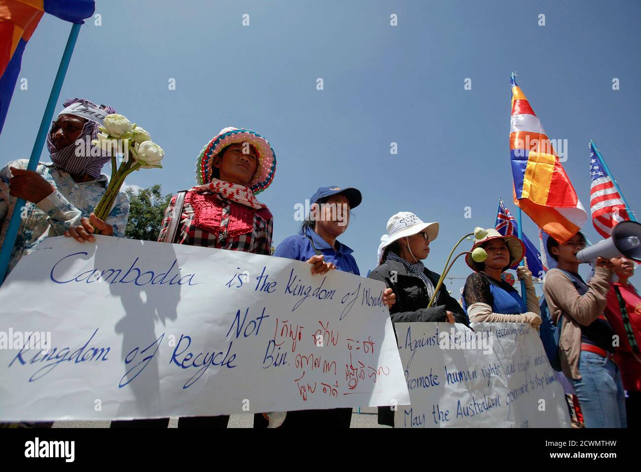 Protesters hold flags and banners as they gather outside the Australian Embassy Phnom Penh October 17, 2014. Protesters rallied in front of Australian Embassy in Phnom Penh against a recent signing