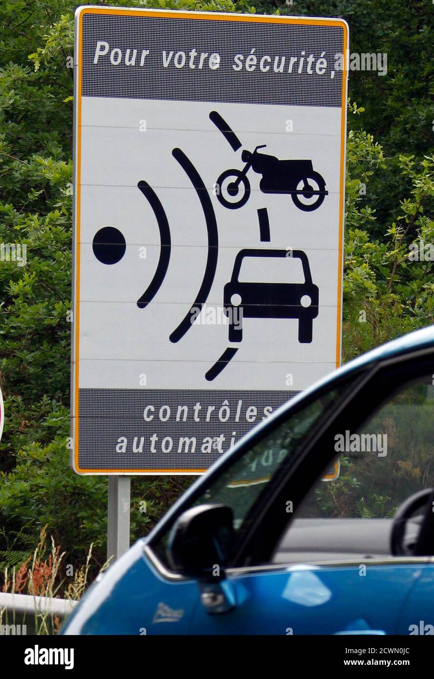 A car drives past a roadside traffic speed radar placard in Saint Jean d' Illac near Bordeaux, southwestern France, May 12, 2011. The French  government decided to toughen sanctions against speeding and driving