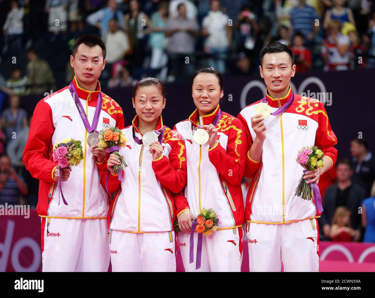 Silver medalists China's Xu Chen (L to R) and Ma Jin with their compatriots  golden medalists Zhao Yunlei and Zhang Nan pose for media during the  victory ceremony for the badminton mixed