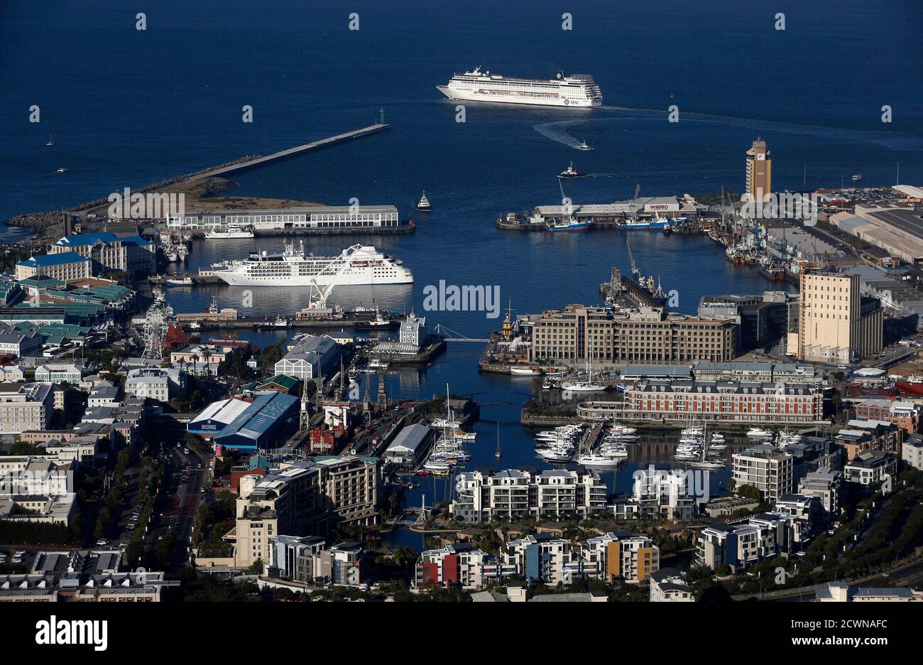 Cruise liner MSC Symphony sails past Cape Town's popular Waterfront district in this picture taken January 27, 2014. With most sectors struggling to grow after a 2009 recession, tourism has stood out as a rare bright spot, as the weaker rand makes it cheaper for visitors, mostly from Europe, to come and soak up the African sun. Picture taken January 27, 2014. REUTERS/Mike Hutchings (SOUTH AFRICA - Tags: TRAVEL BUSINESS) Stock Photo