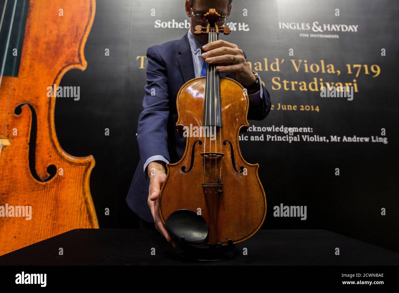 A staff member holds the 'Macdonald' viola made by Italian artisan Antonio  Stradivari in 1719 during a preview before Sotheby's Spring Sales at  Sotheby's gallery in Hong Kong April 4, 2014. The