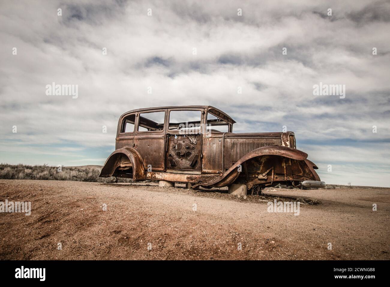 Abandoned Car in the American southwest desert at the Petrified Forest Painted Desert National Park. Stock Photo