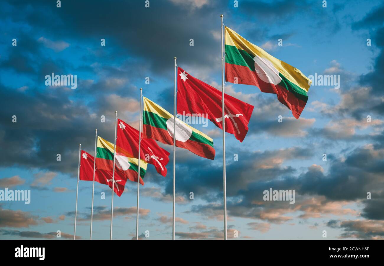 Waving flags of Shan State and Shan State Army South in Myanmar sunset sky background. Stock Photo