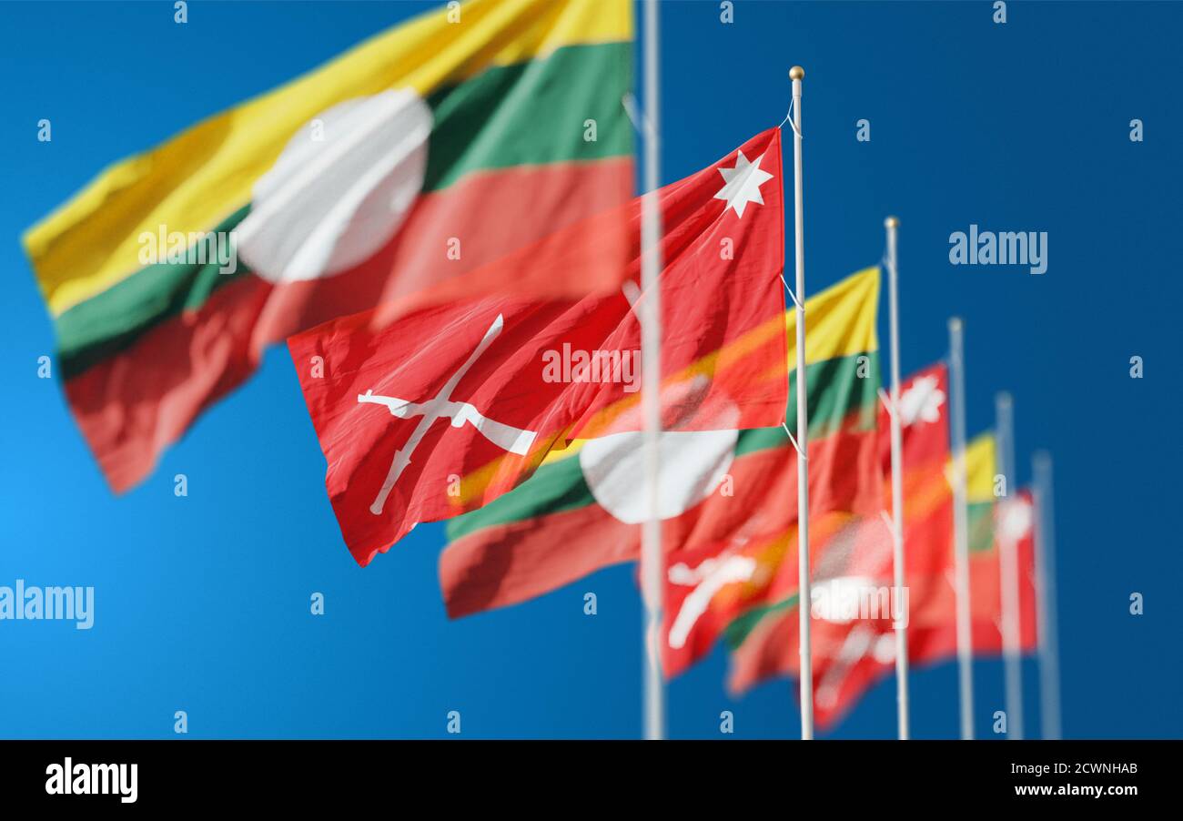 Waving flags of Shan State and Shan State Army South in Myanmar against blue sky background. Stock Photo