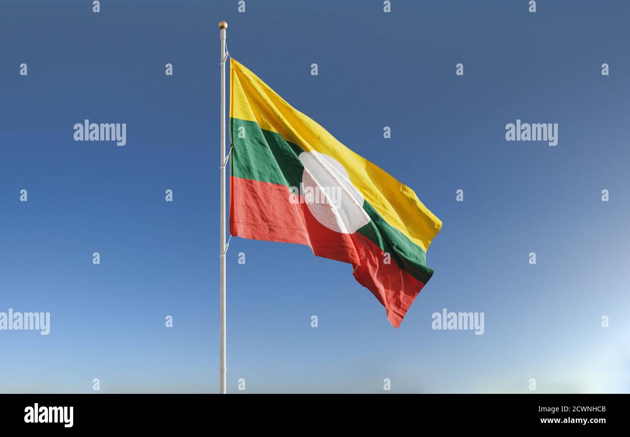 Waving flags of Shan State in Myanmar against blue sky background. Stock Photo