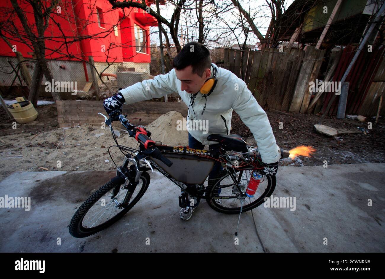 Raul Oaida starts his bicycle propelled with a self-built jet engine in the  yard of his house in Deva, 399 km (245 miles) of Bucharest January 12,  2013. Using his pocket money