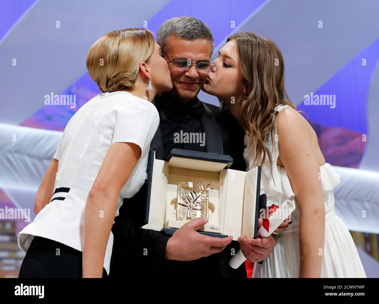 Actresses Lea Seydoux (L) and Adele Exarchopoulos (R) kiss director