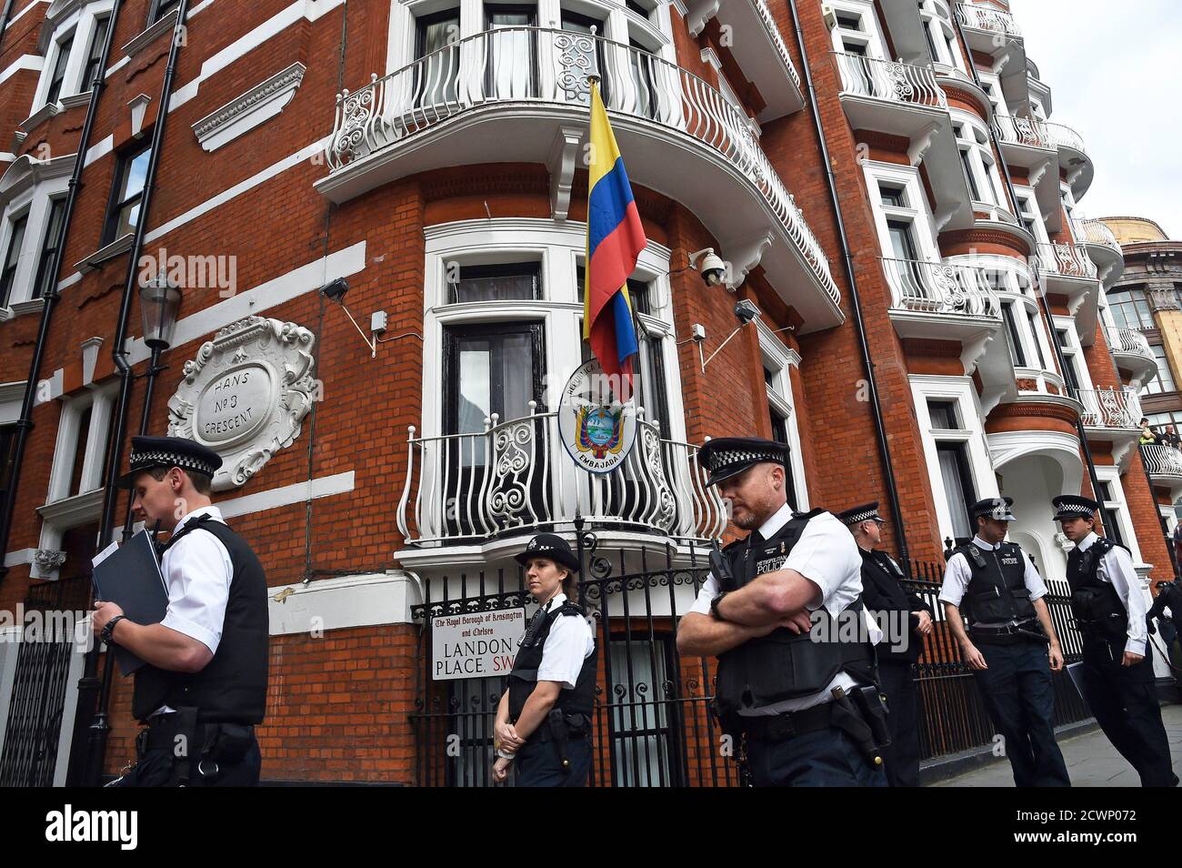Police stand guard during a news conference by WikiLeaks founder Julian Assange at the Ecuadorian embassy in central London August 18, 2014.     REUTERS/Toby Melville (BRITAIN  - Tags: CRIME LAW POLITICS TPX IMAGES OF THE DAY) Stock Photo