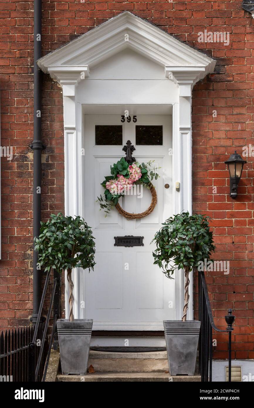 The front door of an English Victorian home with an autumn wreath hanging from the front door Stock Photo