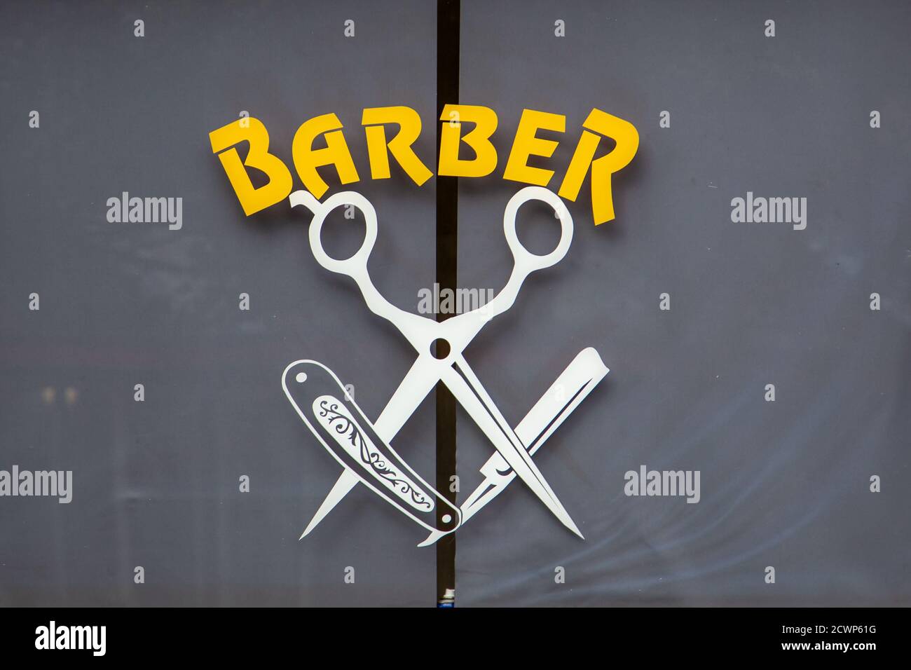 The logo in the window of a barber shop Stock Photo