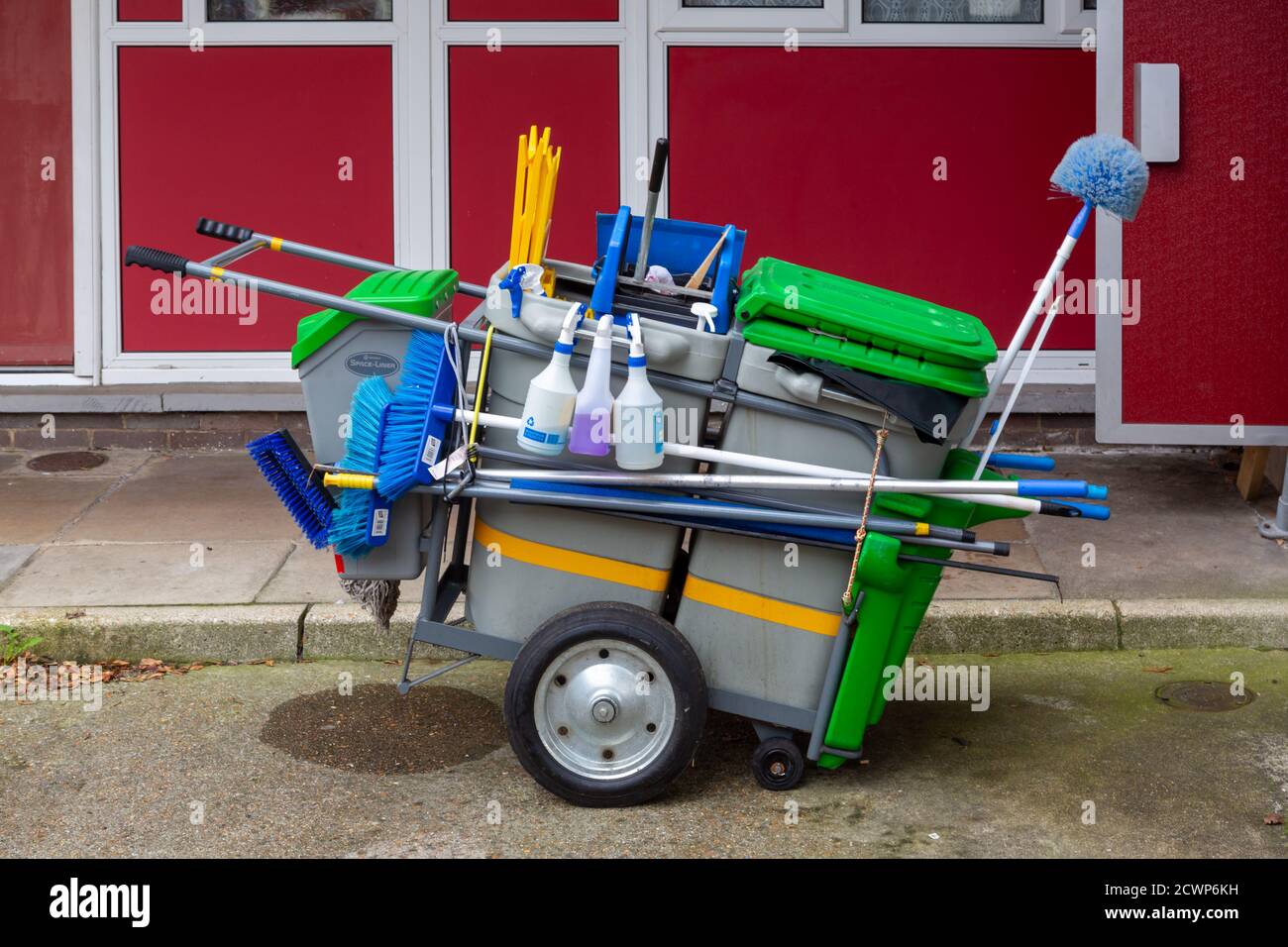 A cleaners trolley with cleaning equipment outside a block of flats Stock Photo
