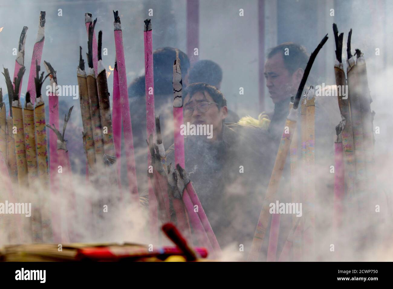 Local residents burn incense as they pray for good fortune outside Dafo Temple on the Lantern Festival, the last day of Chinese Lunar New Year celebrations, in Zhengding County, Hebei province, February 6, 2012. REUTERS/Jason Lee (CHINA - Tags: SOCIETY RELIGION) Stock Photo