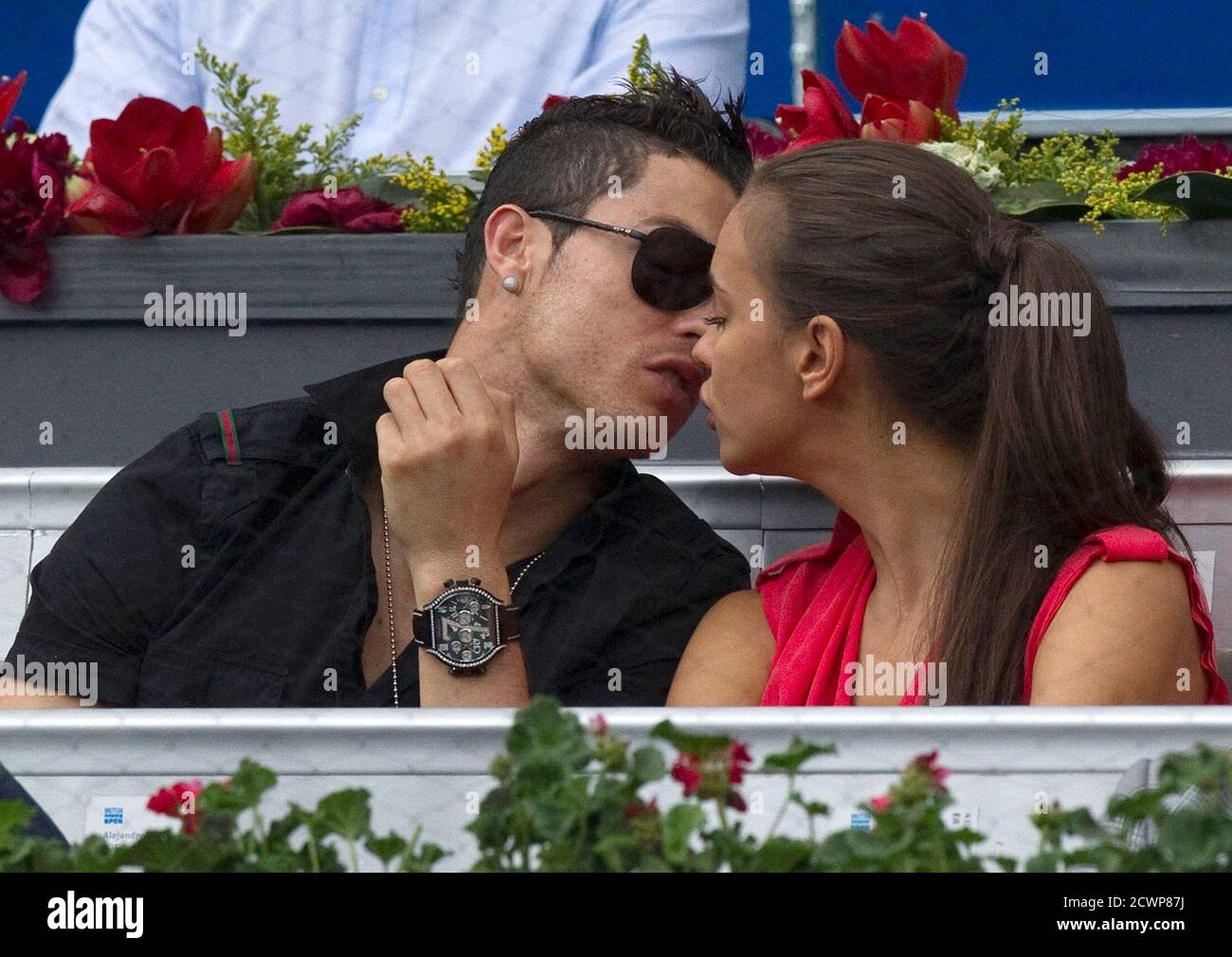 Real Madrid's Cristiano Ronaldo (L) and his girlfriend Irina Shayk kiss  during the men's semi-final match between Roger Federer of Switzerland and  Janko Tipsarevic of Serbia at the Madrid Open tennis tournament